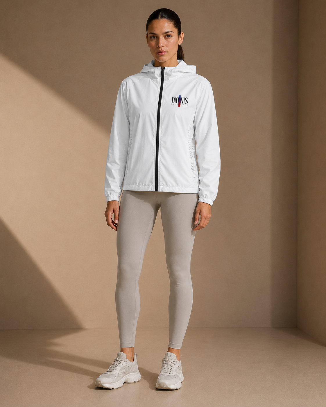Woman wearing a white jacket with a logo on a beige background