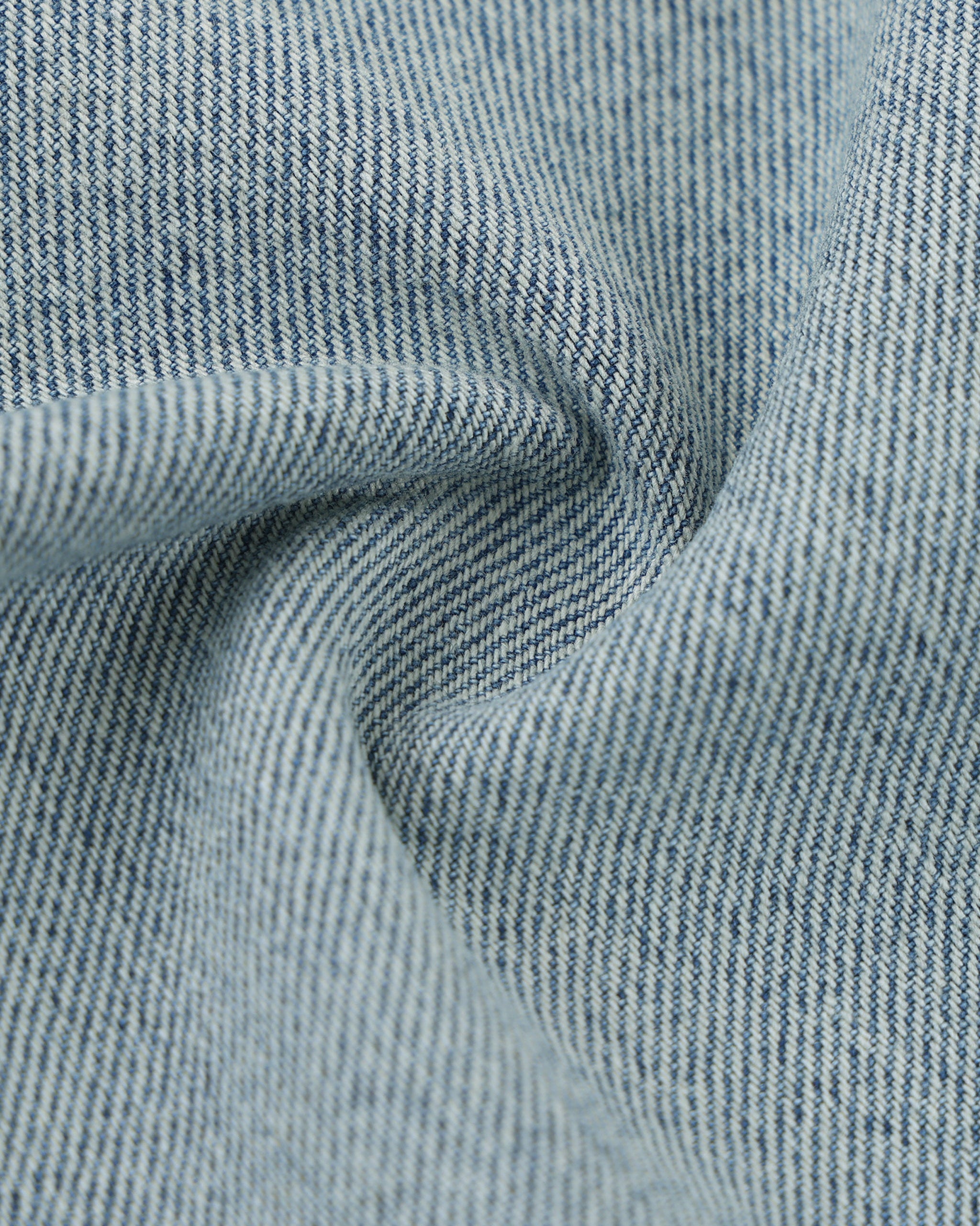 Close-up of textured blue fabric with a subtle pattern