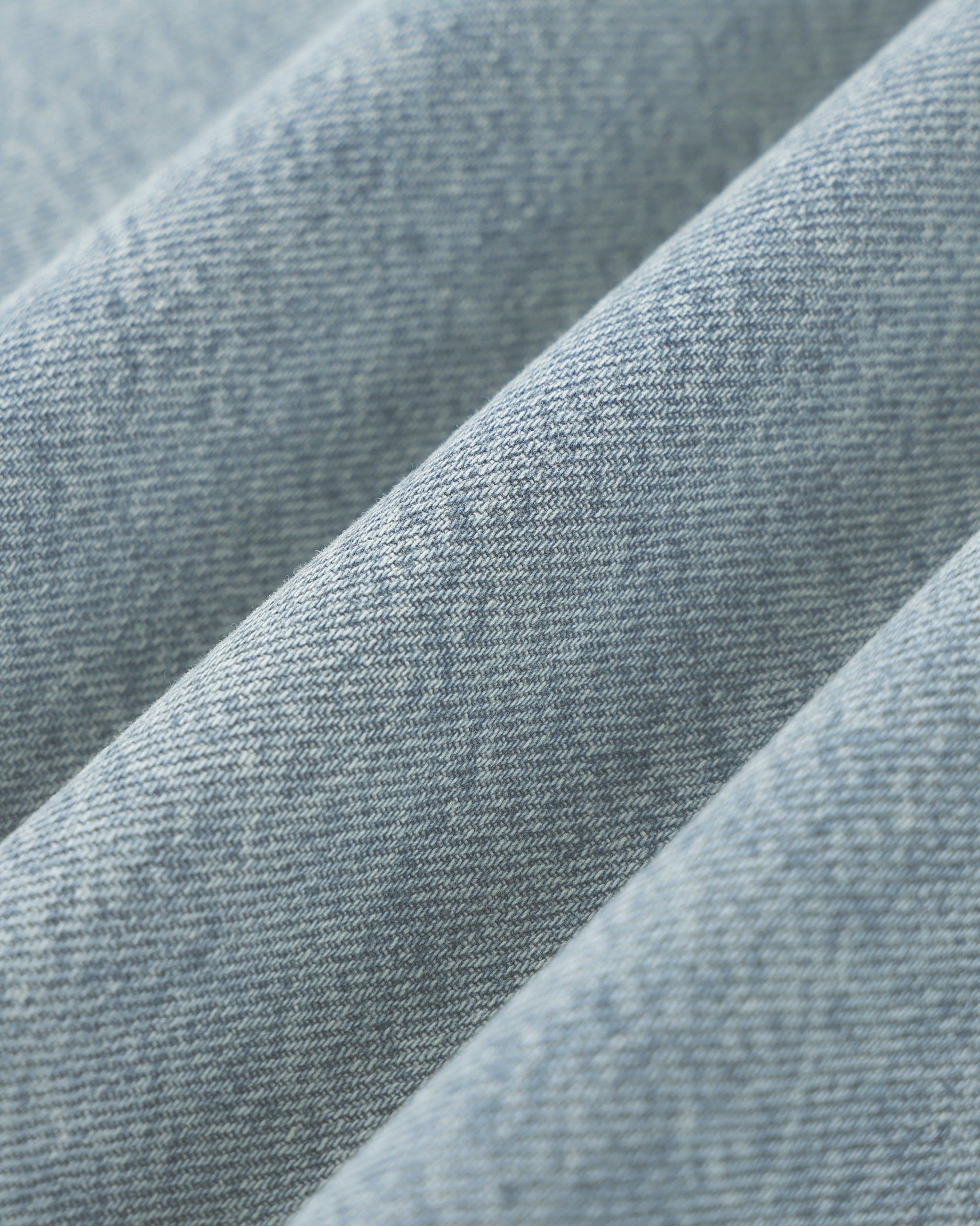 Close-up of blue denim fabric with a subtle pattern
