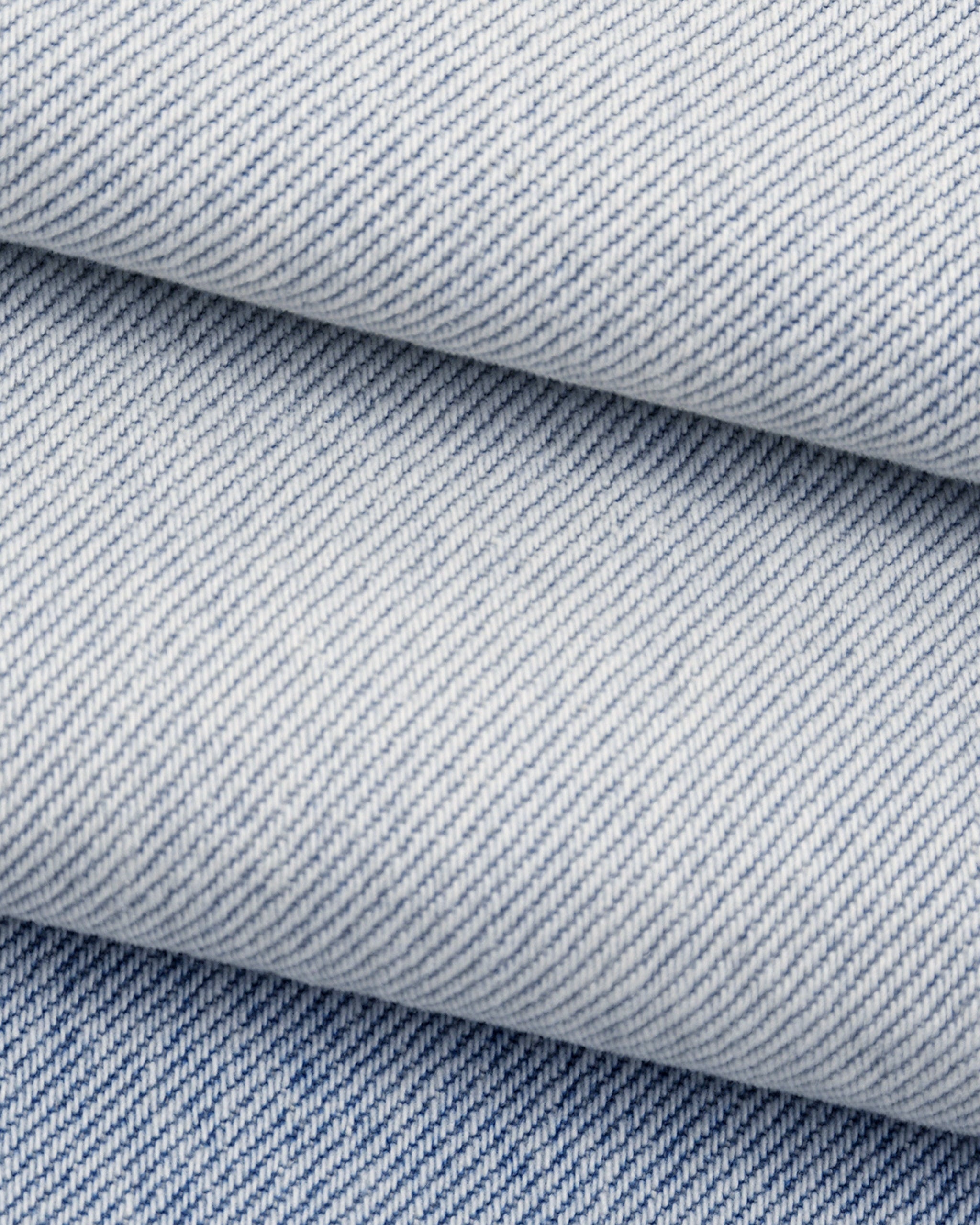Close-up of blue denim fabric with a subtle pattern