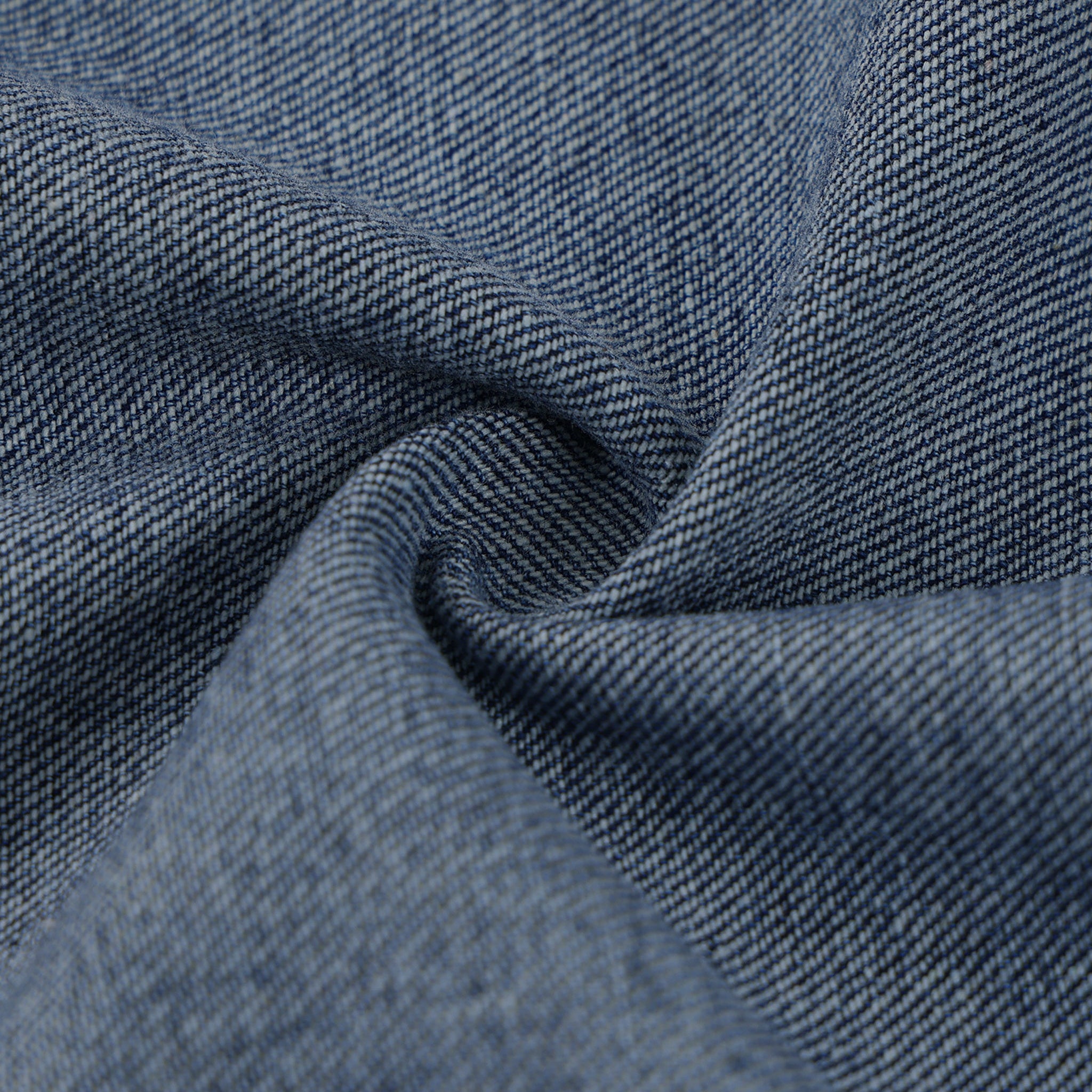 Close-up of blue denim fabric with a textured pattern
