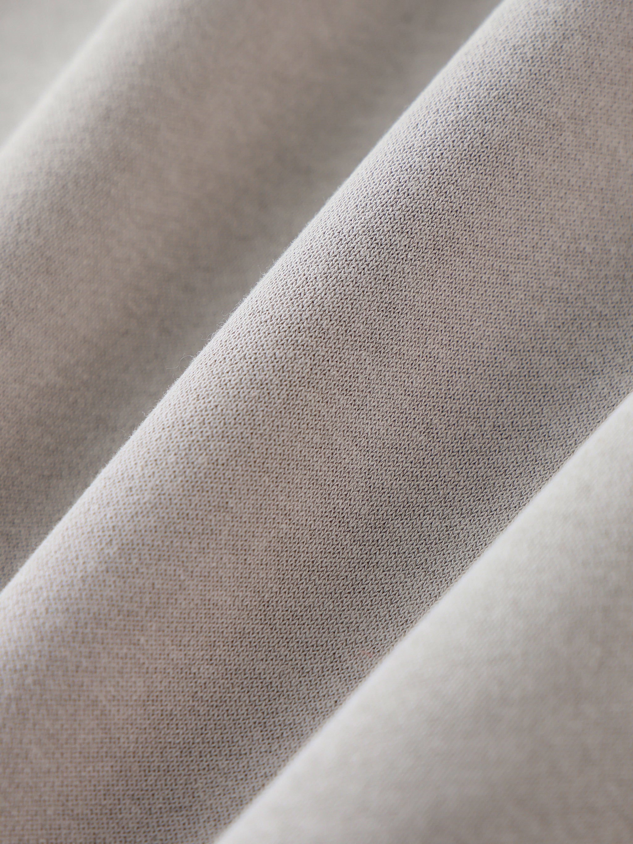 Close-up of beige fabric with a subtle pattern
